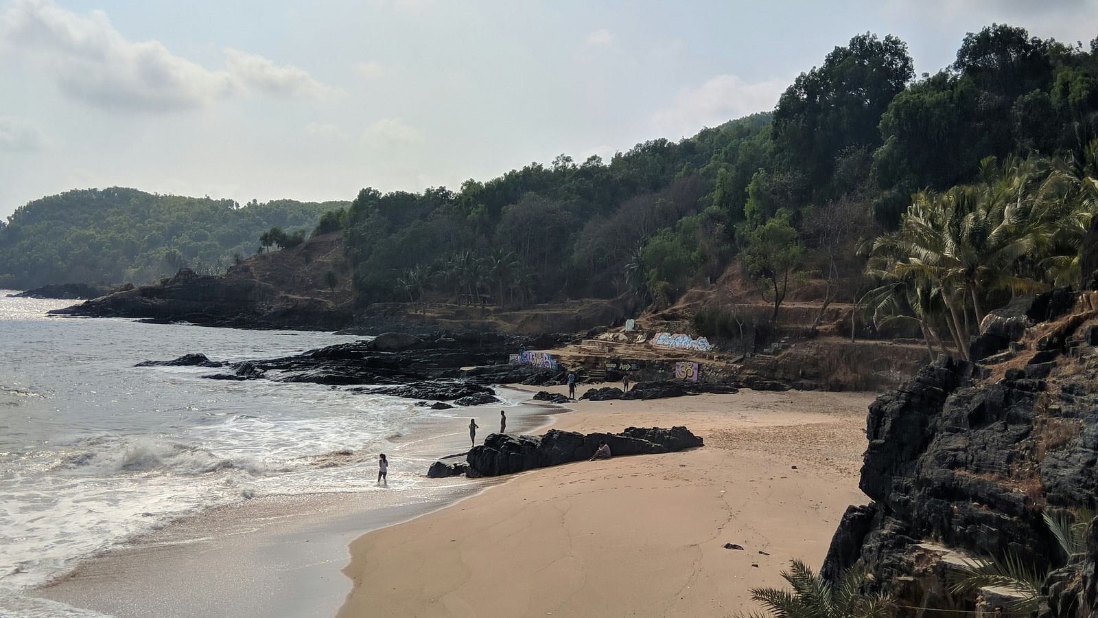 a far out view of a beach in Gokarna with water overlapping on the beach