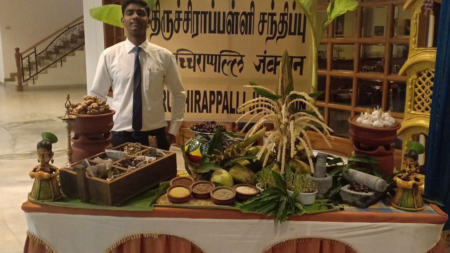 Man behind a table filled with a variety of food at SRM Hotel Tiruchirappalli- Hotel 