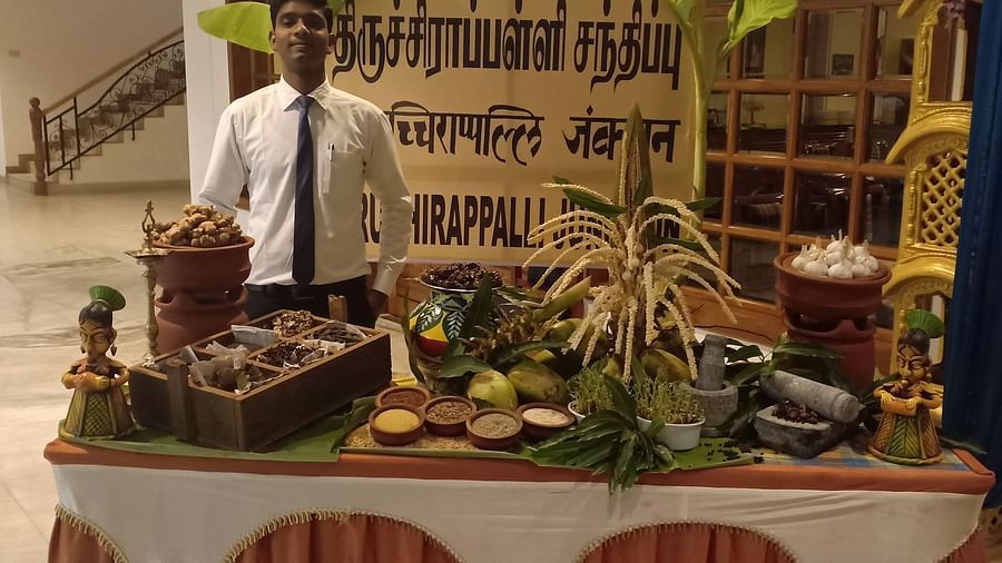 Man behind a table filled with a variety of food at SRM Hotel Tiruchirappalli- Hotel 