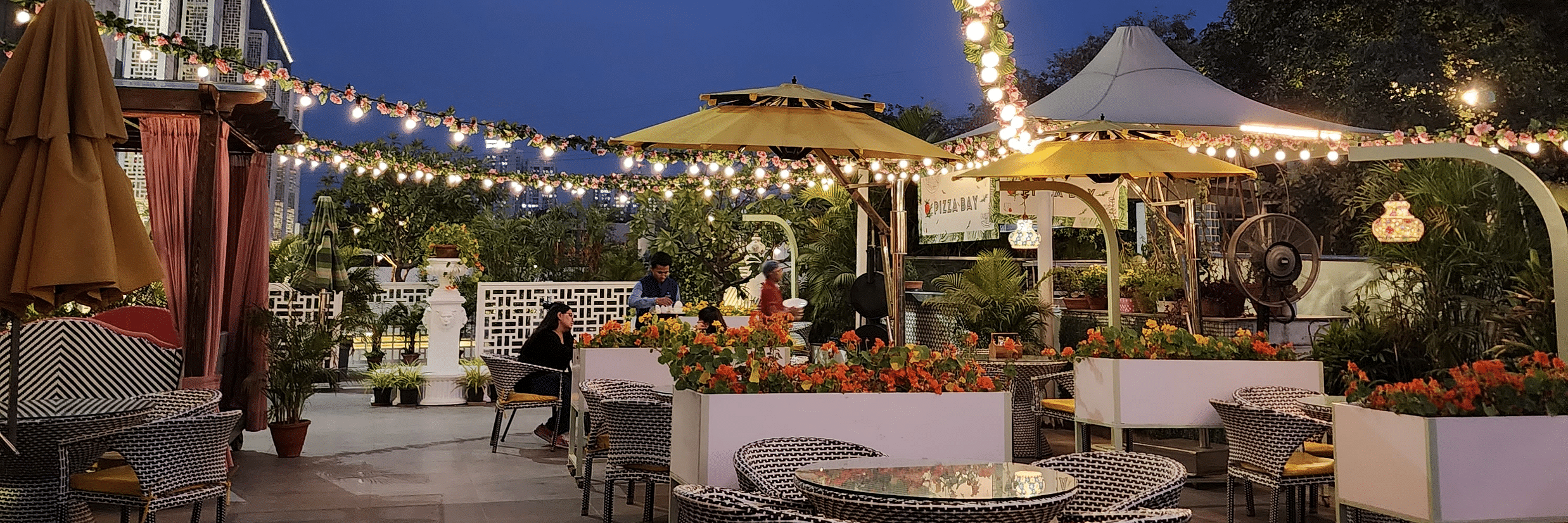 Outdoor seating arrangement at Pizza Bay - Karma Lakelands.