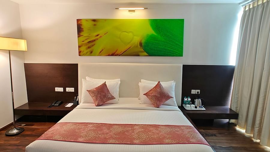 Suite Room with a luxurious and cosy king sized bed and a bedside lamp beside at Springs Hotel & Spa