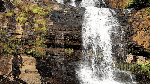 a waterfall flowing over rocky cliffs