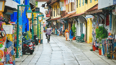 Colourful market street with traditional Indian shops and signboards.