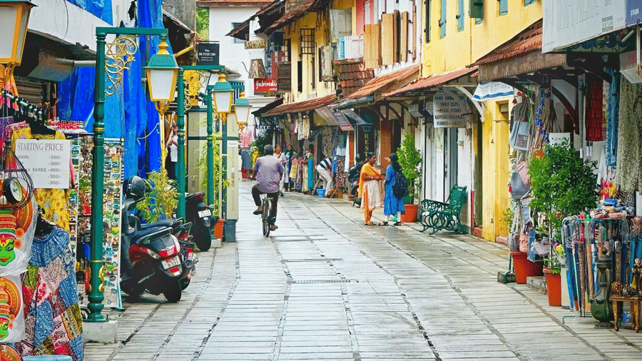 Colourful market street with traditional Indian shops and signboards.