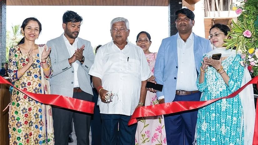 An image of a people standing behind a red ribbon to inaugurate cake revealing ceremony - Cloud9 Sarovar Premiere, Palolem Goa 
