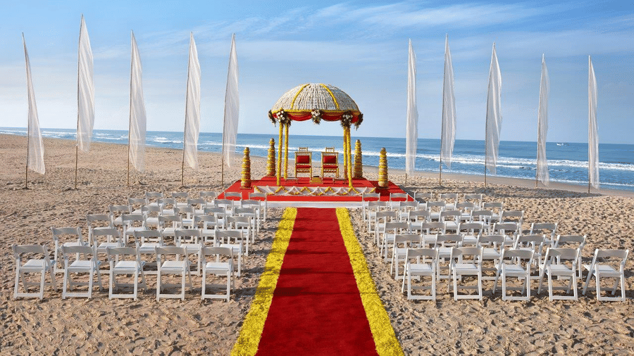 overview of the Beach Wedding Setup with seats and a stage area - Caravela Beach Resort Goa.