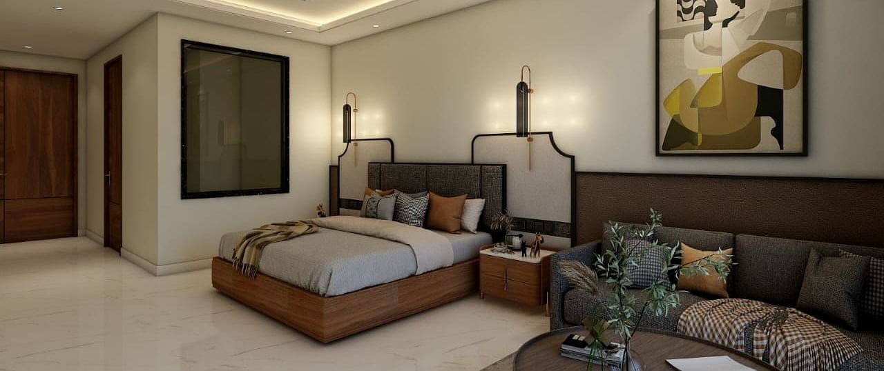 A bedroom with slightly low lighting featuring a double bed with an artistic head board along with a common seating area besides it. - Namaste Corbett