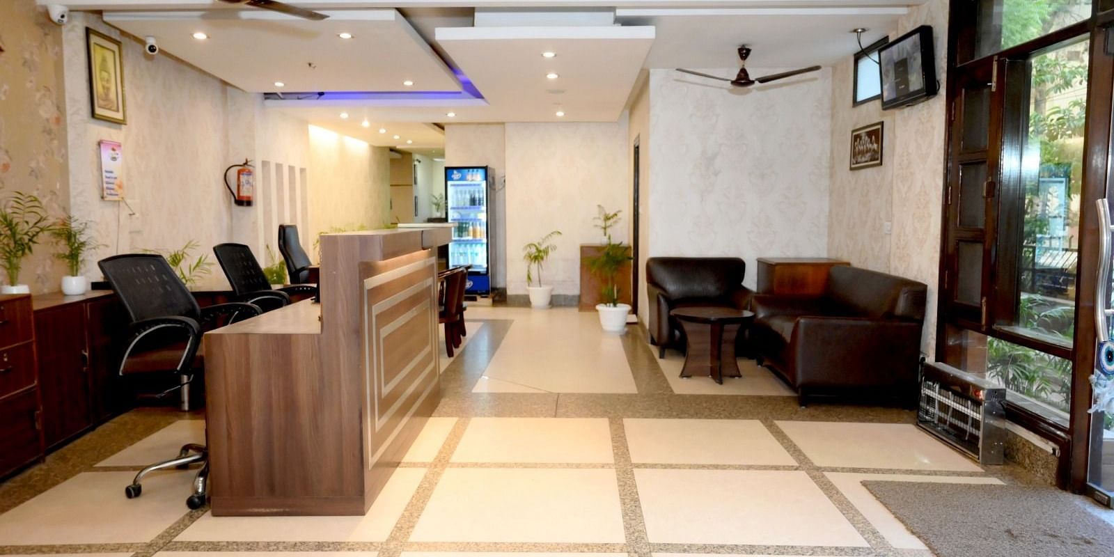 A bright and airy hotel lobby with a reception counter and comfortable seating for guests - Hotel Diamond Inn, Chandigarh