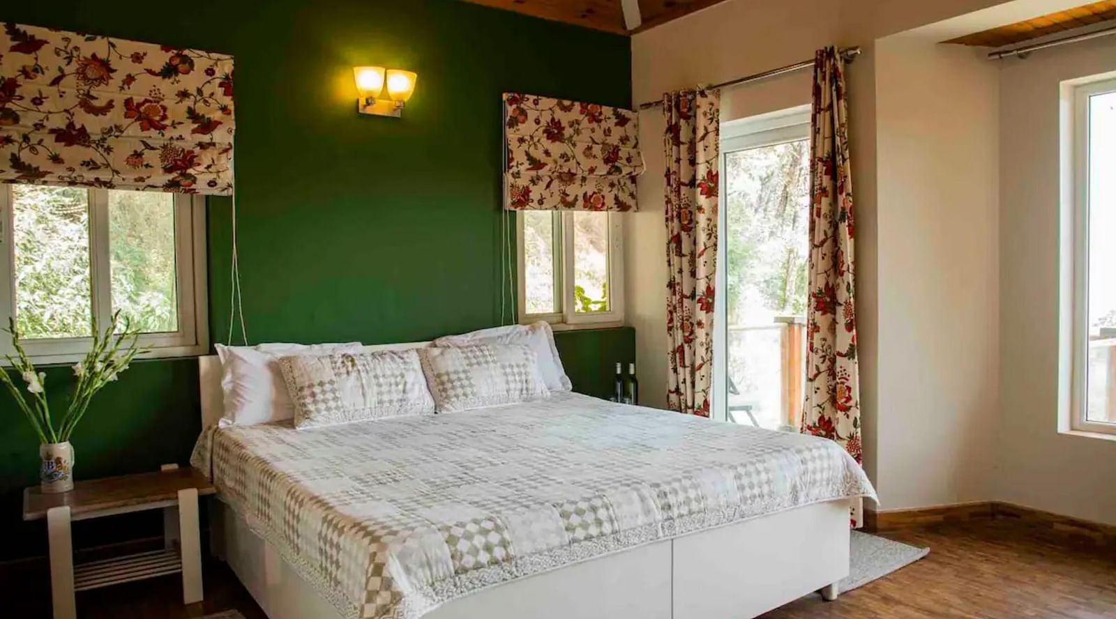 A large bed in a bedroom next to a nightstand and nightlamp above in 3 BHK at  at SOUTHGATE KASAULI BY ZENQ.