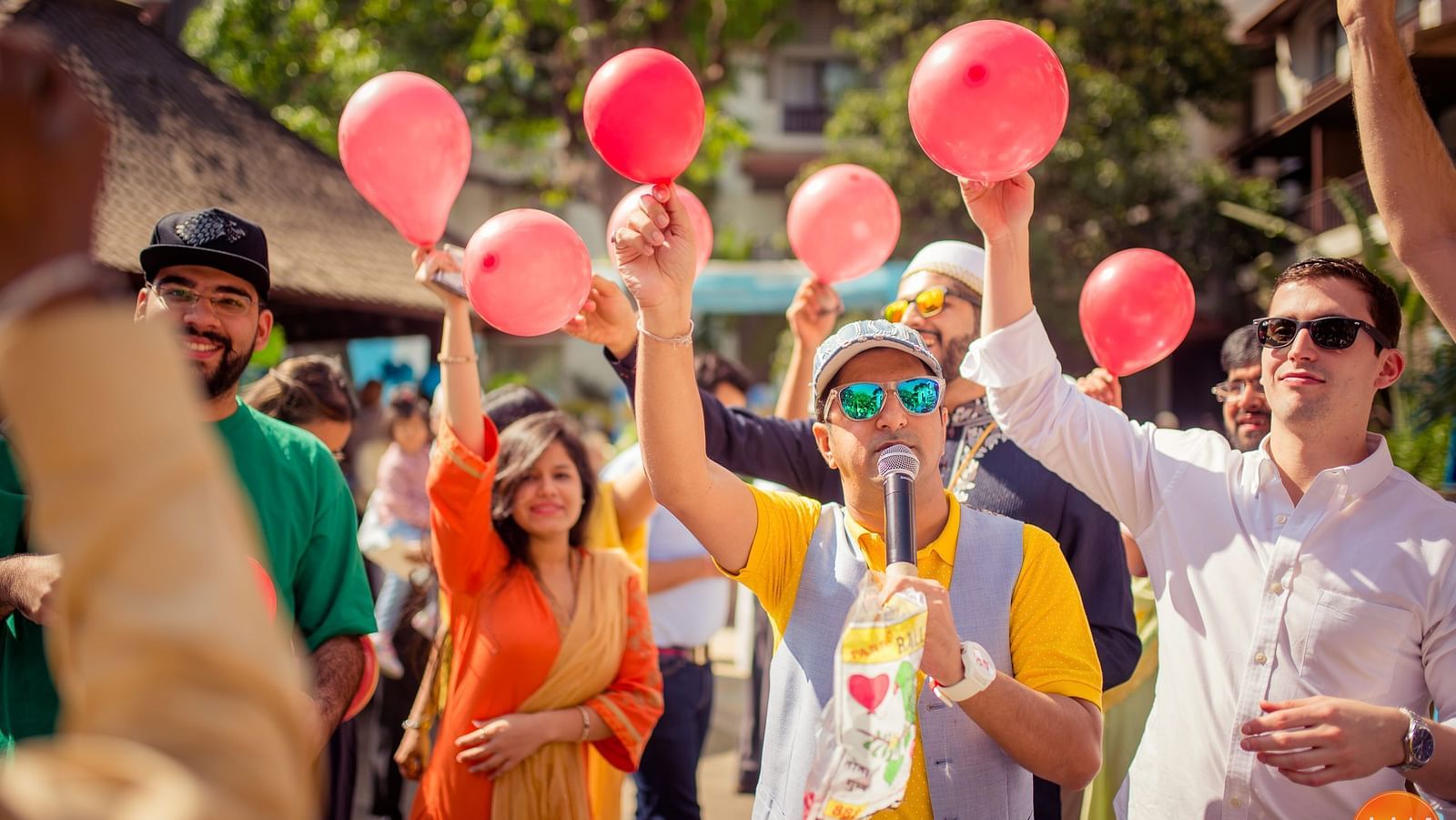 People holding pink balloon - Rhythm Lonavala
