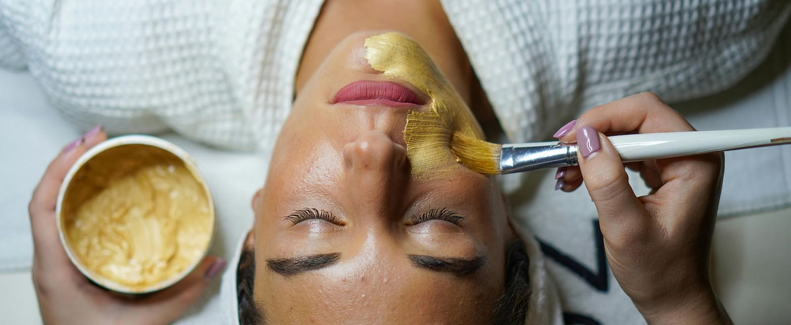A woman getting a facial done.