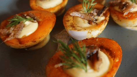 Gourmet stuffed potato bites garnished with fresh herbs, served at a modern Newari restaurant in Patan, Nepal.
