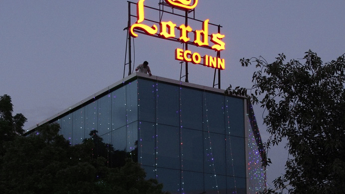 A modern, multi-storey building with a sign and a glass exterior.