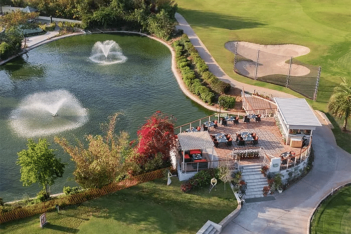 Aerial view of Karma Chalets’ landscaped grounds with fountains, greenery, and outdoor seating.