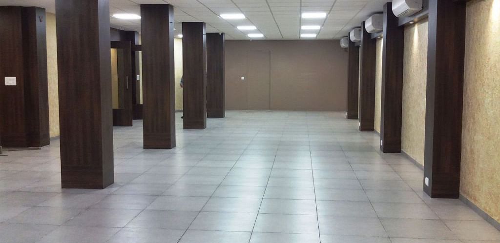 Spacious corridor or hall with tiled floor and wooden columns