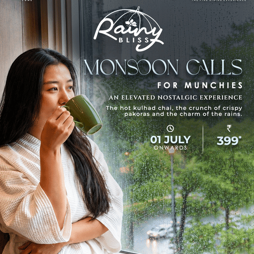 Woman sipping hot kulhad chai by a rainy window with crispy pakoras and vada pav, promoting the Rainy Bliss Monsoon Offer at Casablanca.