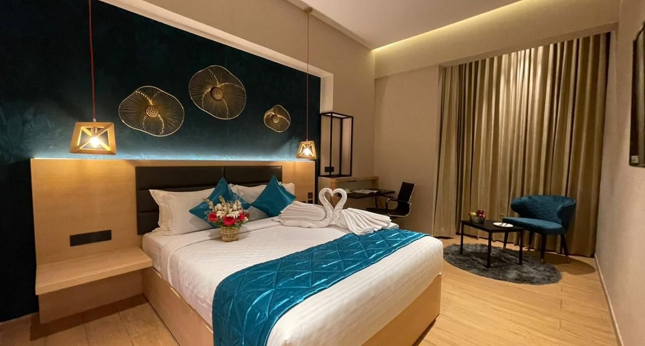Double bed with blue sheets at Premium Room at Le Foliage by TGI, Bangalore