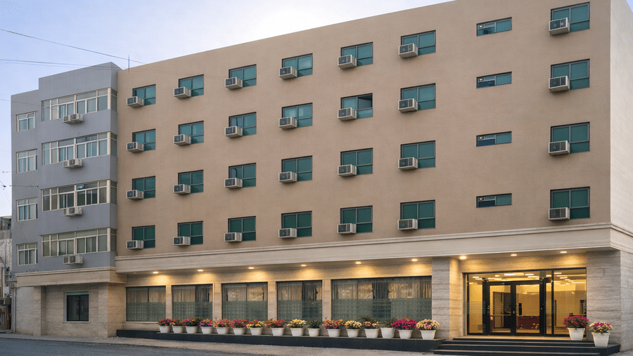 Full view of multi-story hotel facade from street level.