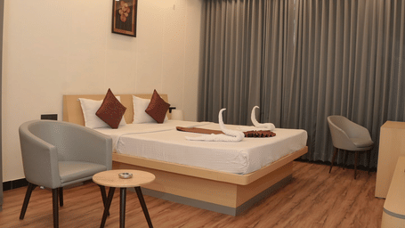 Executive room with king size bed seating area and modern interiors at Ram Bhawan Ram Yamuna Prasad Hotel and Resort.