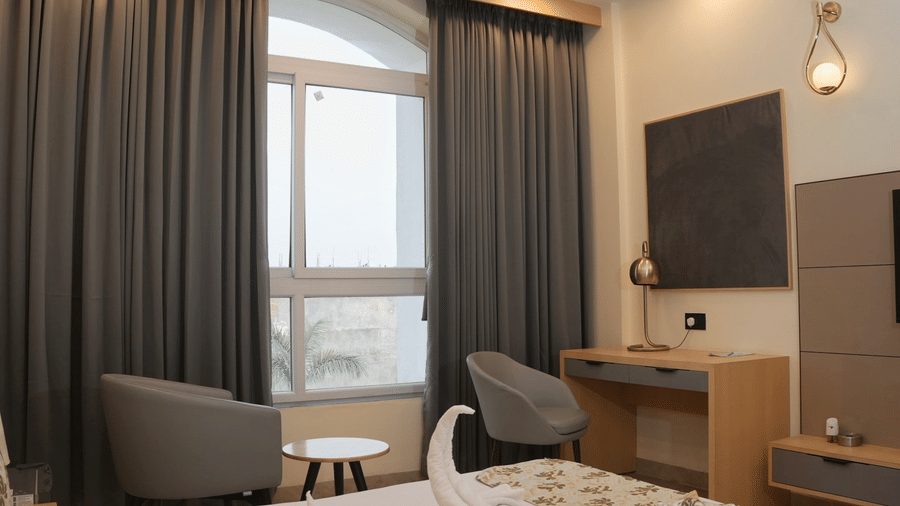 Modern executive room with cosy bed seating area and work desk at Ram Bhawan Ram Yamuna Prasad Hotel and Resort