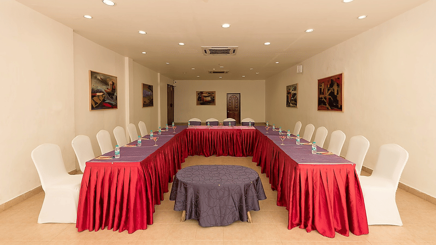 Frangi Pani Hall arranged in a U-shape seating setup with red and purple linens at Chariot Beach Resorts, suited for meetings and events.