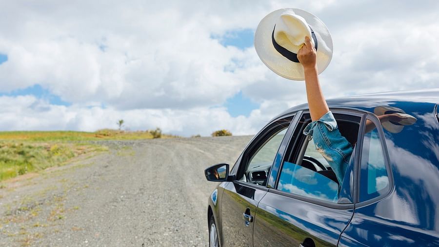 A car driving in empty roads under clear skies