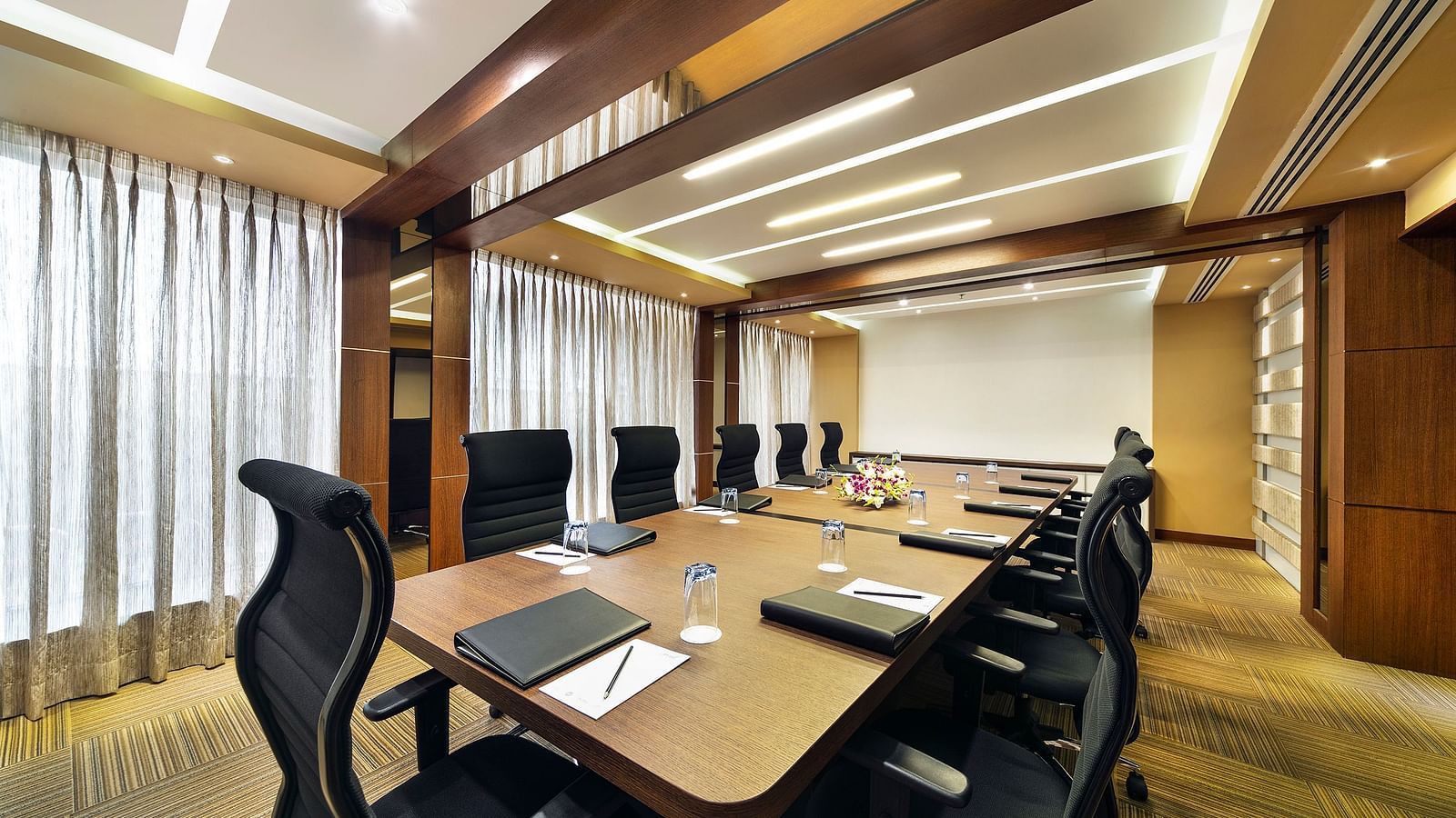 image of a boardroom with a projector at Grand Kakinada by GRT Hotels