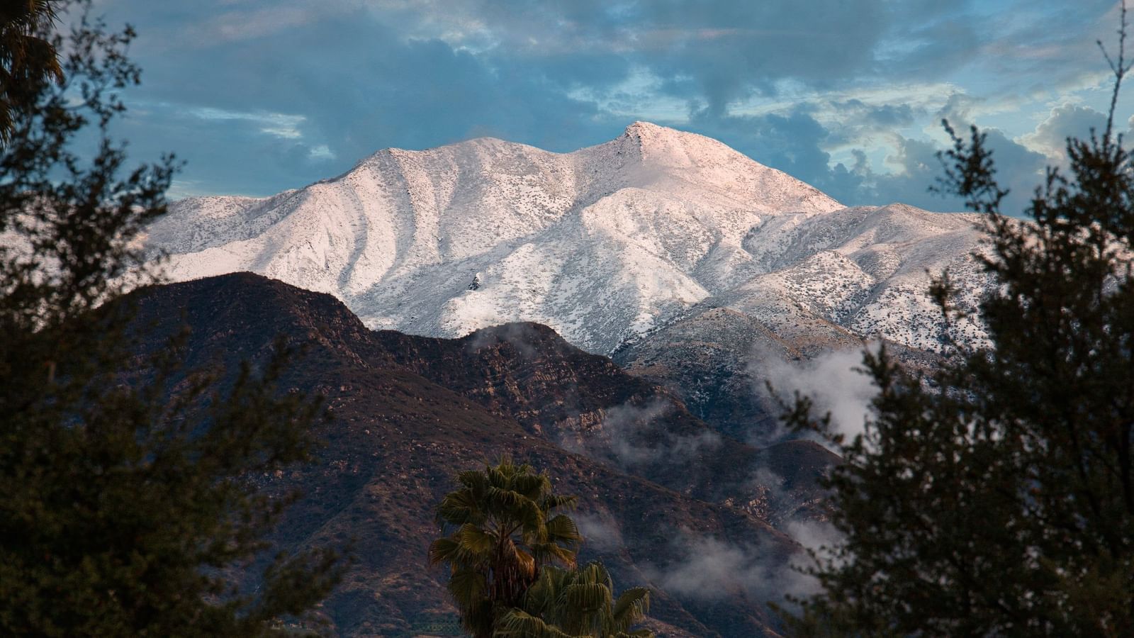 Experience stunning views of a snow-covered mountain, a scenic attraction near the Tallman Hotel.