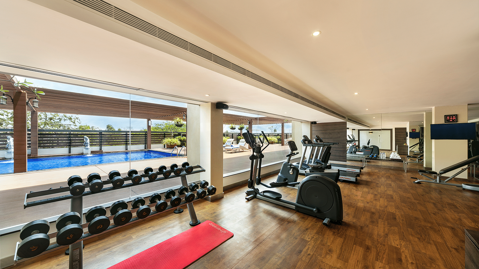 image of a gym with equippments at A side view of the lobby with sofa sets at Grand Kakinada by GRT Hotels
