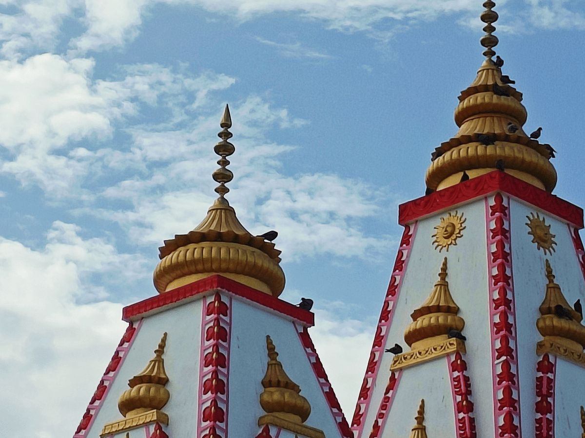 The temple shikhara rising above the trees at Daksh Mahadev Temple, Haridwar