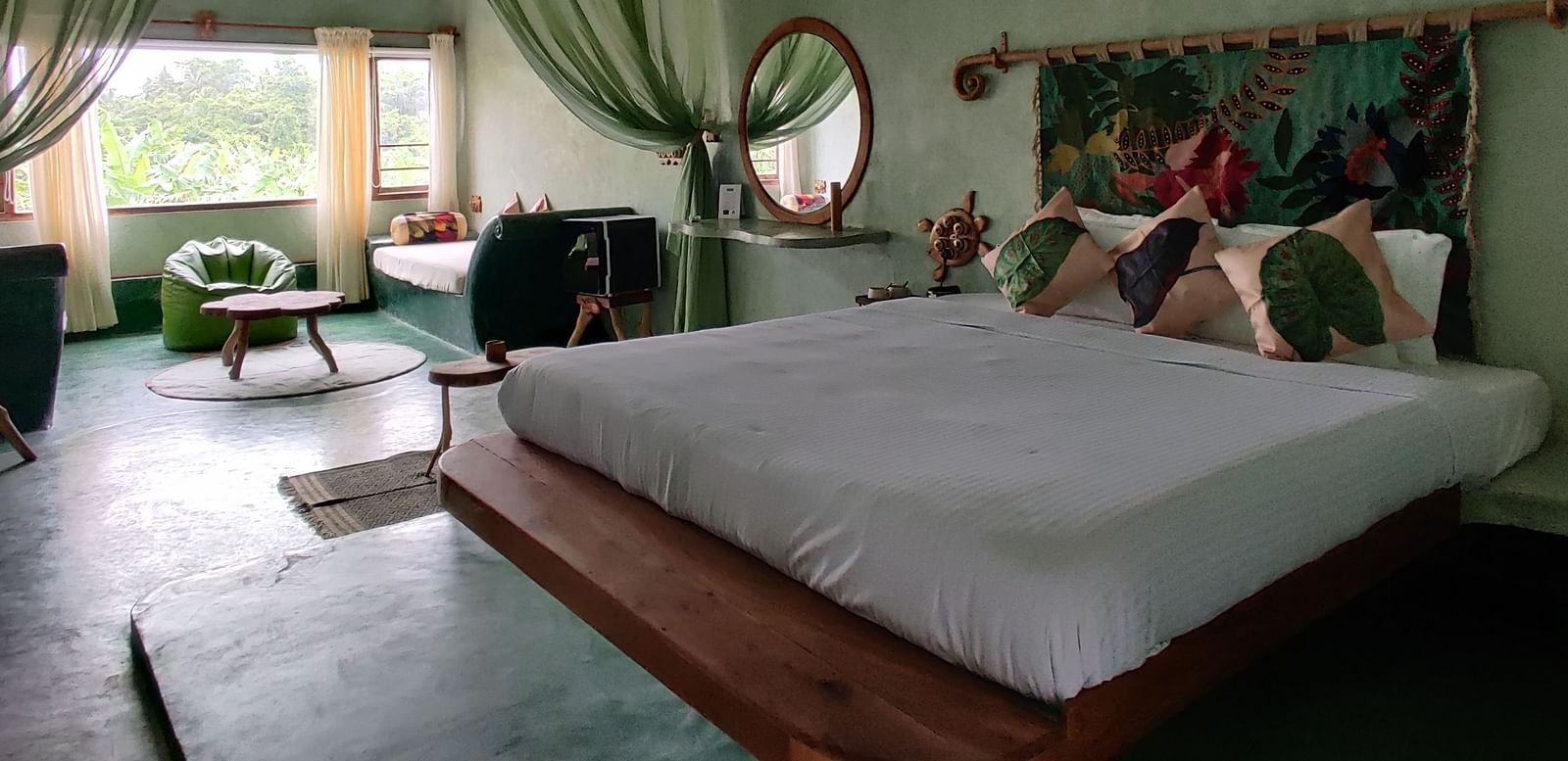 Bed in the room beside a living room | Matsya Island Retreat