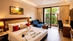 Pool View Room at Sobit Sarovar Portico, Goa featuring a king size bed, modern interiors, flat-screen TV, minibar, work area and elegant décor, offering a comfortable stay with premium in-room amenities.