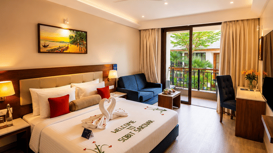 Pool View Room at Sobit Sarovar Portico, Goa featuring a king size bed, modern interiors, flat-screen TV, minibar, work area and elegant décor, offering a comfortable stay with premium in-room amenities.