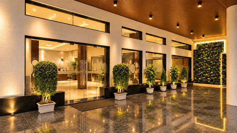 Polished indoor entrance hallway with glossy flooring and potted plants at Bhavani's Vista By Icon, Hosur.   