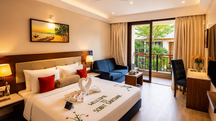 Pool View Room at Sobit Sarovar Portico, Goa featuring a king size bed, modern interiors, flat-screen TV, minibar, work area and elegant décor, offering a comfortable stay with premium in-room amenities.