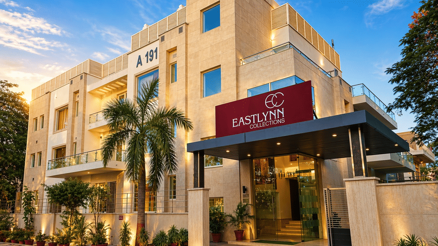 The exterior view of Eastlynn Collections HUDA City Centre, Gurugram showcasing a clean façade, entrance canopy, and landscaped surroundings.