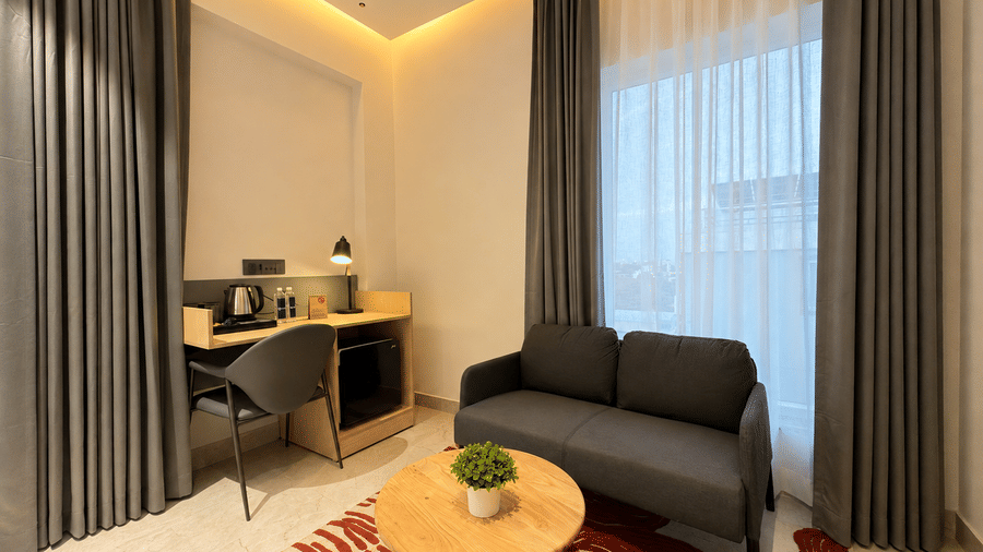 Luxury Suite bed and sofa corner – Hotel Kyzen, Shamshabad Airport, Hyderabad