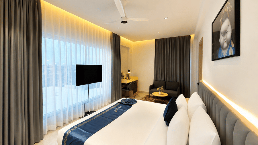 Luxury Suite bed with TV and lounge – Hotel Kyzen, Shamshabad Airport, Hyderabad