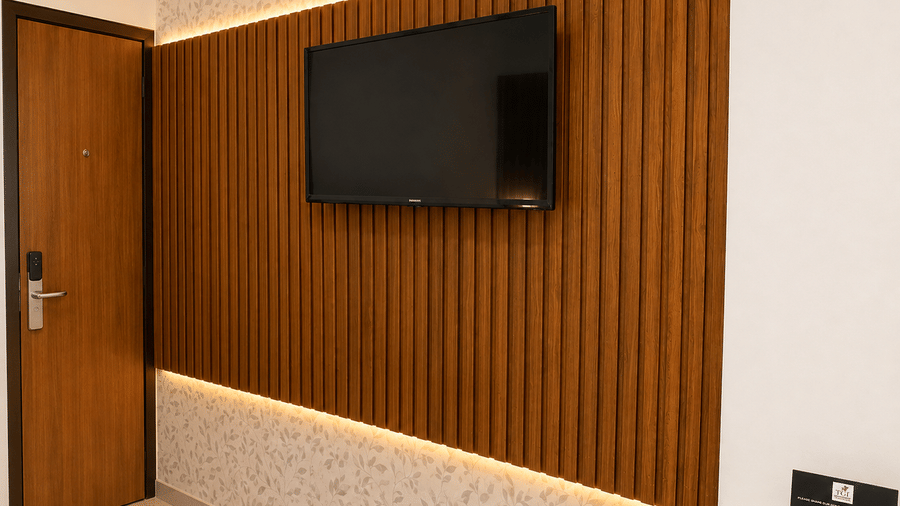 Premium Room at TGI Apple Inn, Ajmer Road, Jaipur featuring a television mounted on a wall panel beside a door.