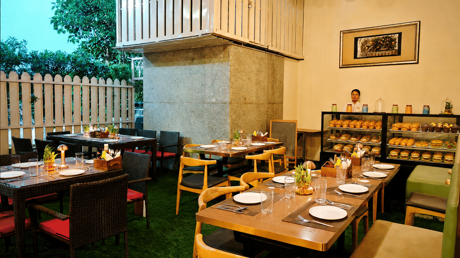 Open seating area at Cafe Latina with comfortable dining arrangements, warm interiors, and a welcoming ambience perfect for casual dining experiences.