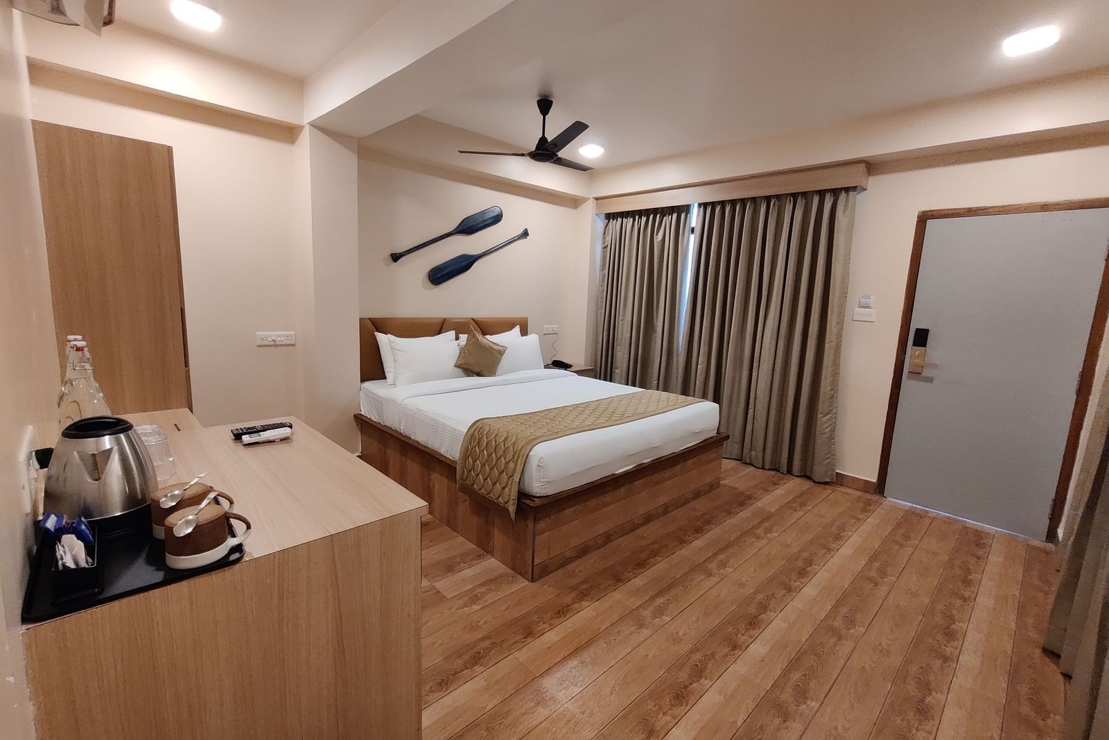 Modern bedroom with a king-sized bed, minimalist design, and wooden accents