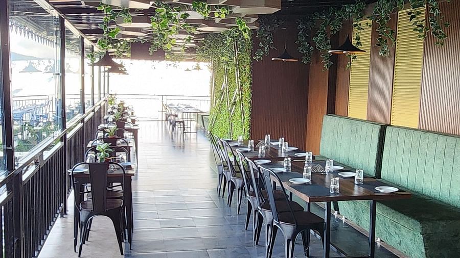 Tables and chairs in the dining area that has mountain views | Voyage The Royal Retreat 