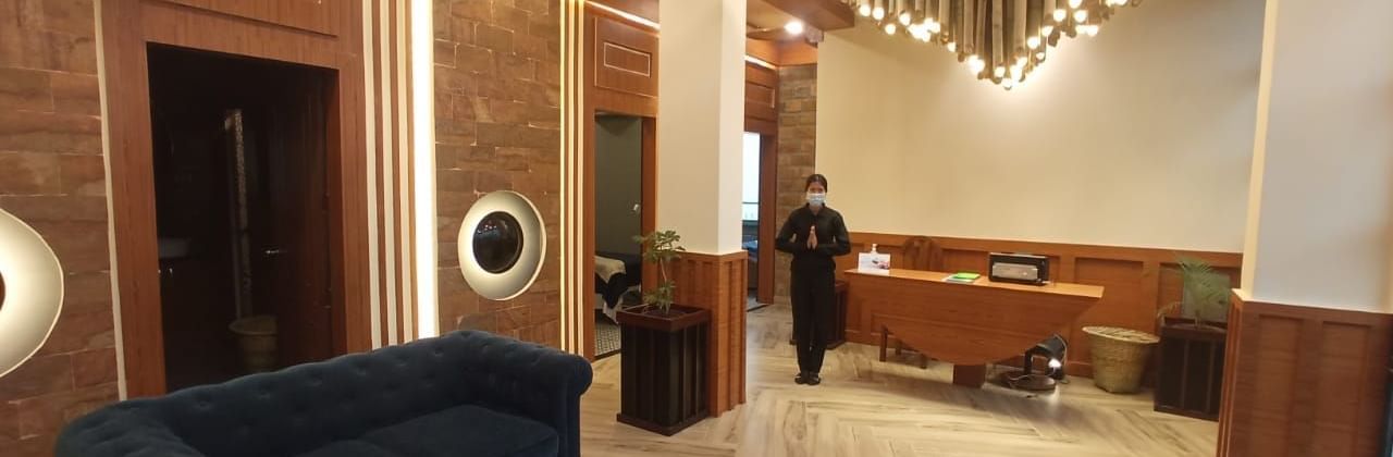 Lobby seating area with wooden interiors at Polo Resort Cherrapunjee.