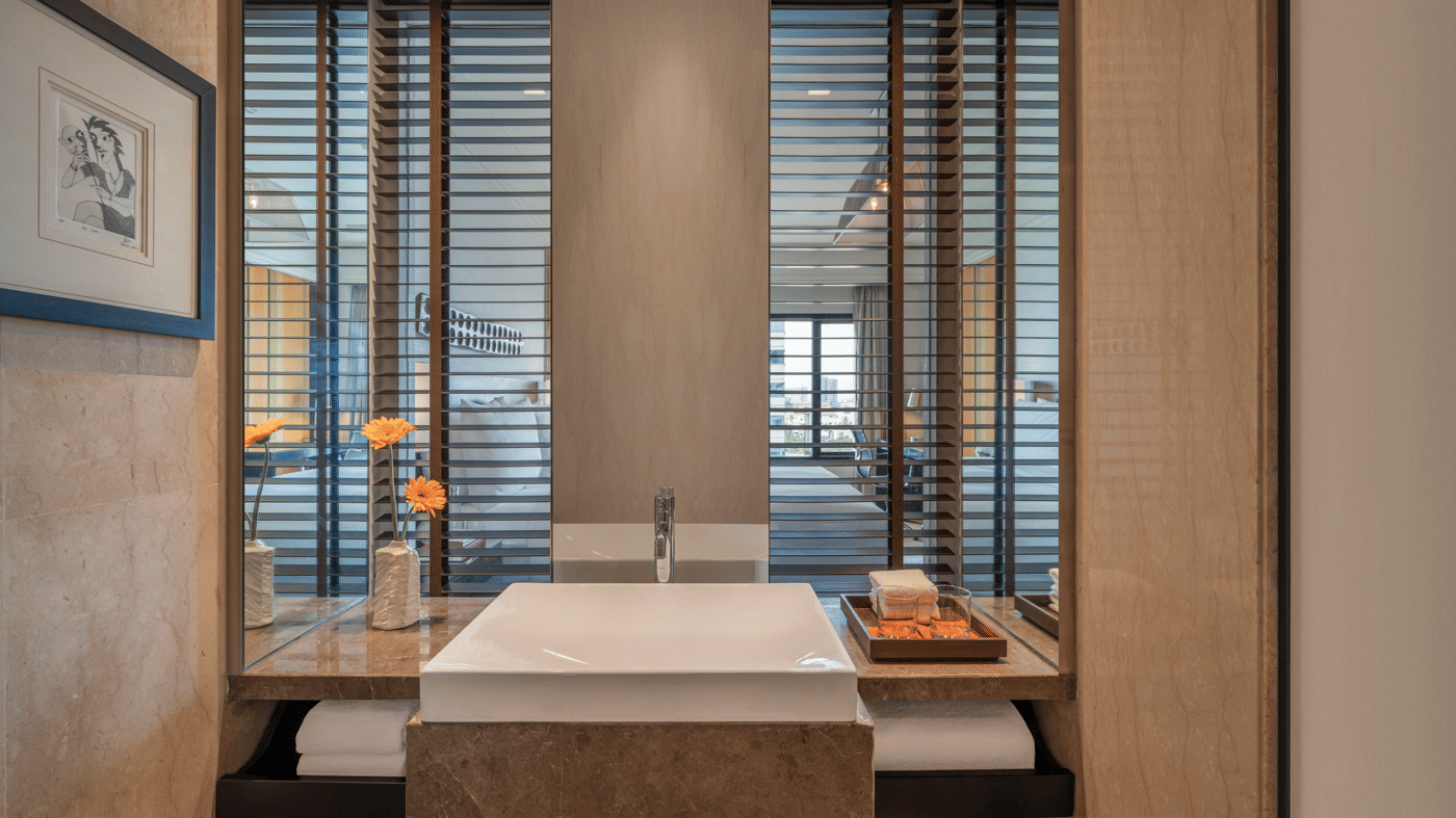 Bathroom with bathtub, sink, and glass divider at The Raintree, St. Mary’s Road.