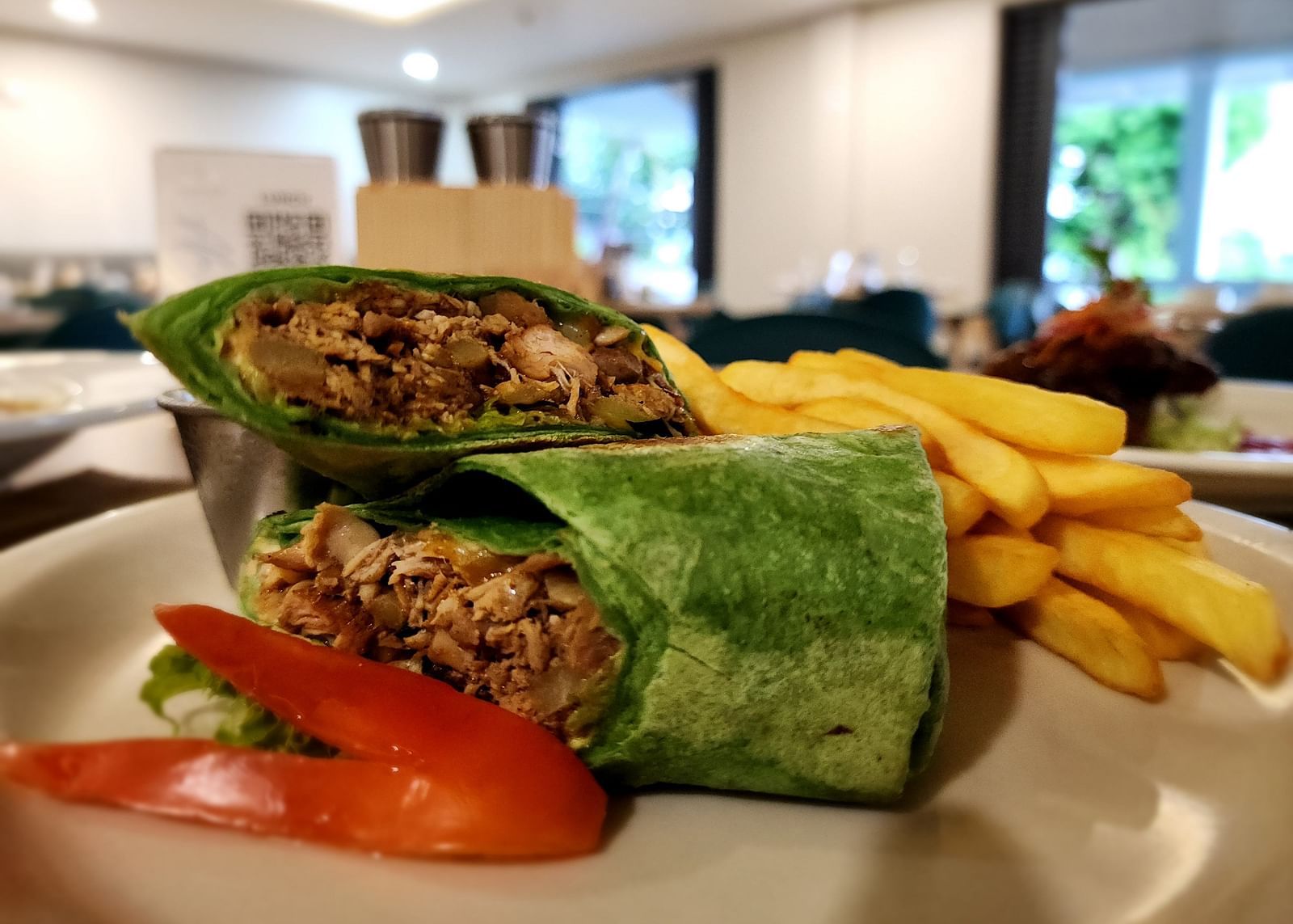 A wrap with fries and fresh veggies on the side - Hotel 39, Jamaica
