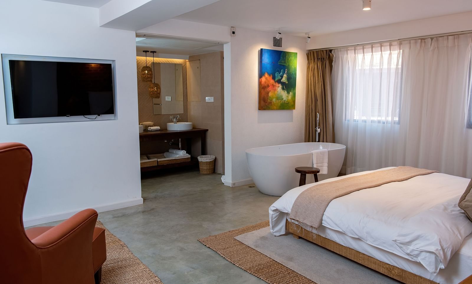 The Nepali Suite featuring a bed, flat screen TV, a sofa and a bathtub - The Nanee