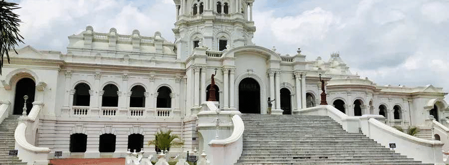A wide shot of two-story white Ujjayanta Palace in Agartala.
