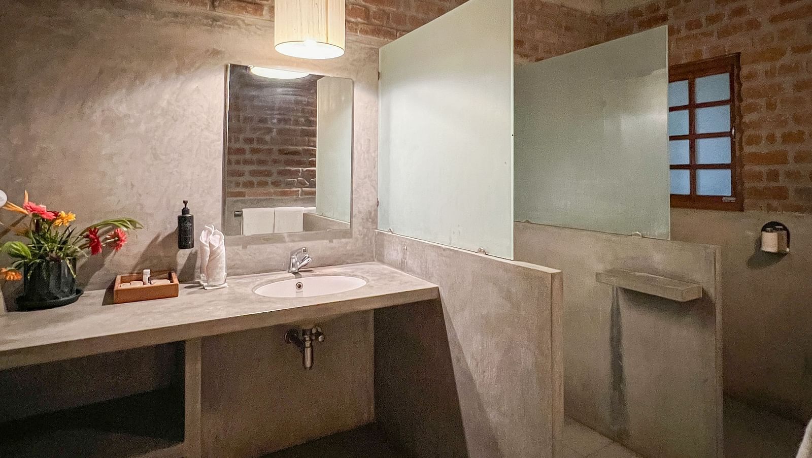 Swiss Chalet Washroom with showering area separated and a table alongside it.