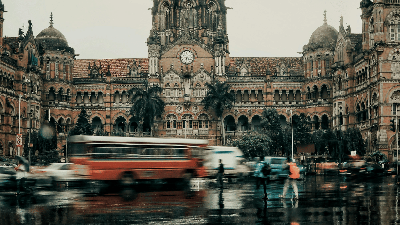 An overview of Chhatrapati Shivaji Maharaj Terminus with vehicles travelling on the road in front of it. It is one of the places to visit in Mumbai during the monsoons.