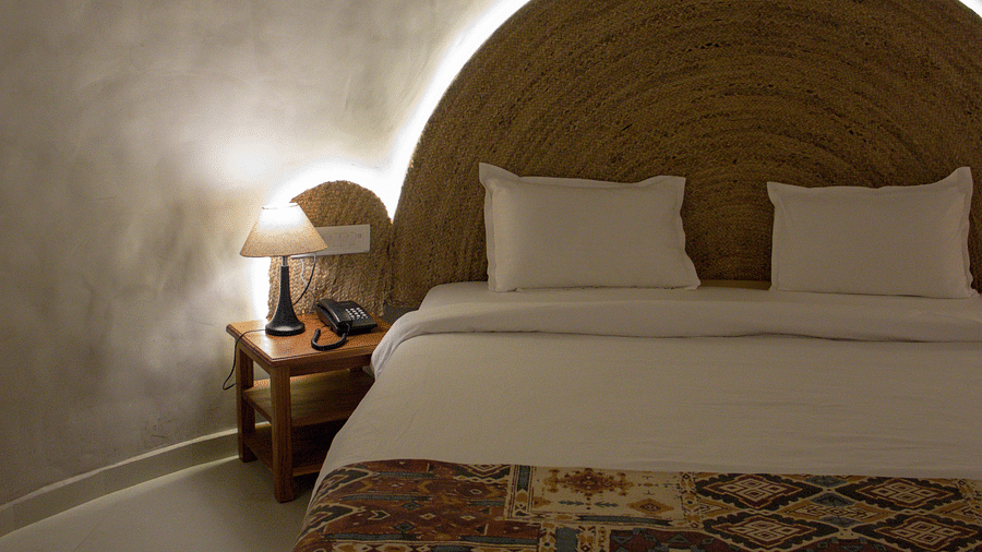 A front view of the room, showcasing the bed softly lit from behind.